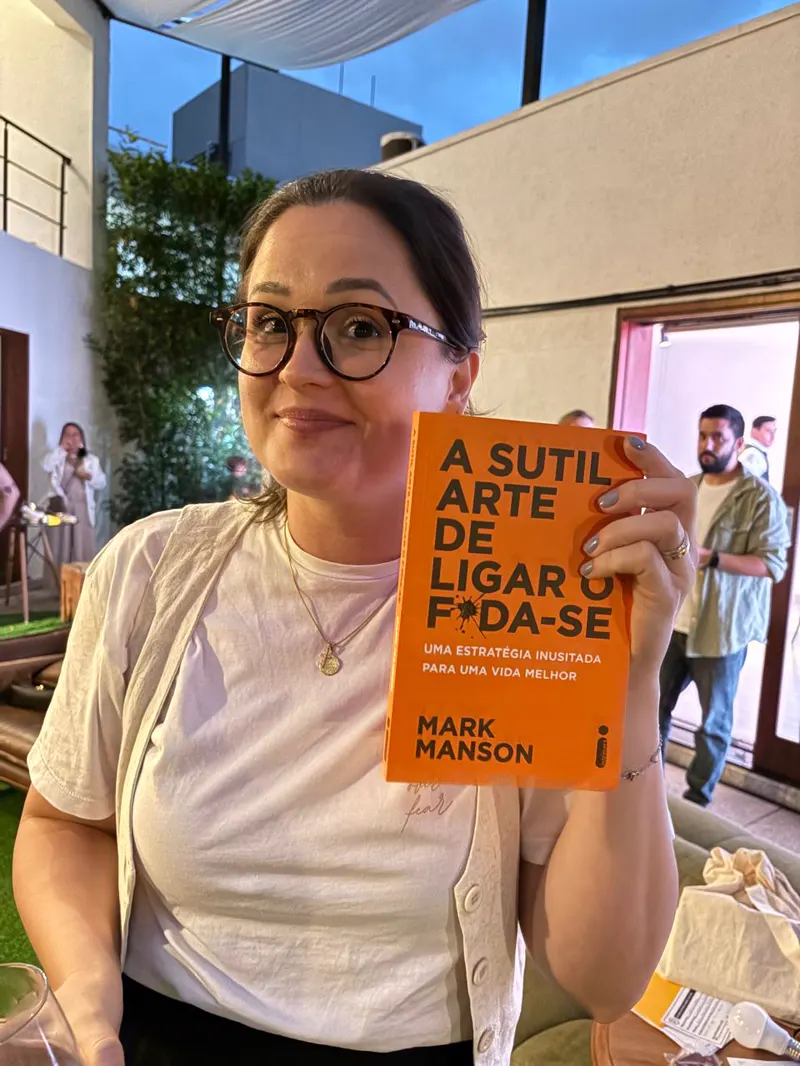 Participante do BAV com o livro A Sutil Arte de Ligar o Foda-se